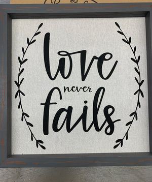 “Love Never Fails" Framed Linen Wall Art